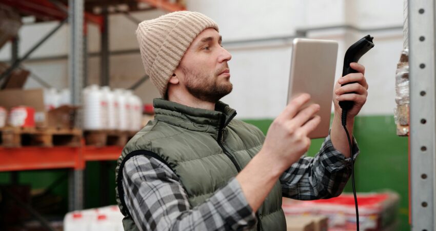 A man checking the inventory using a device